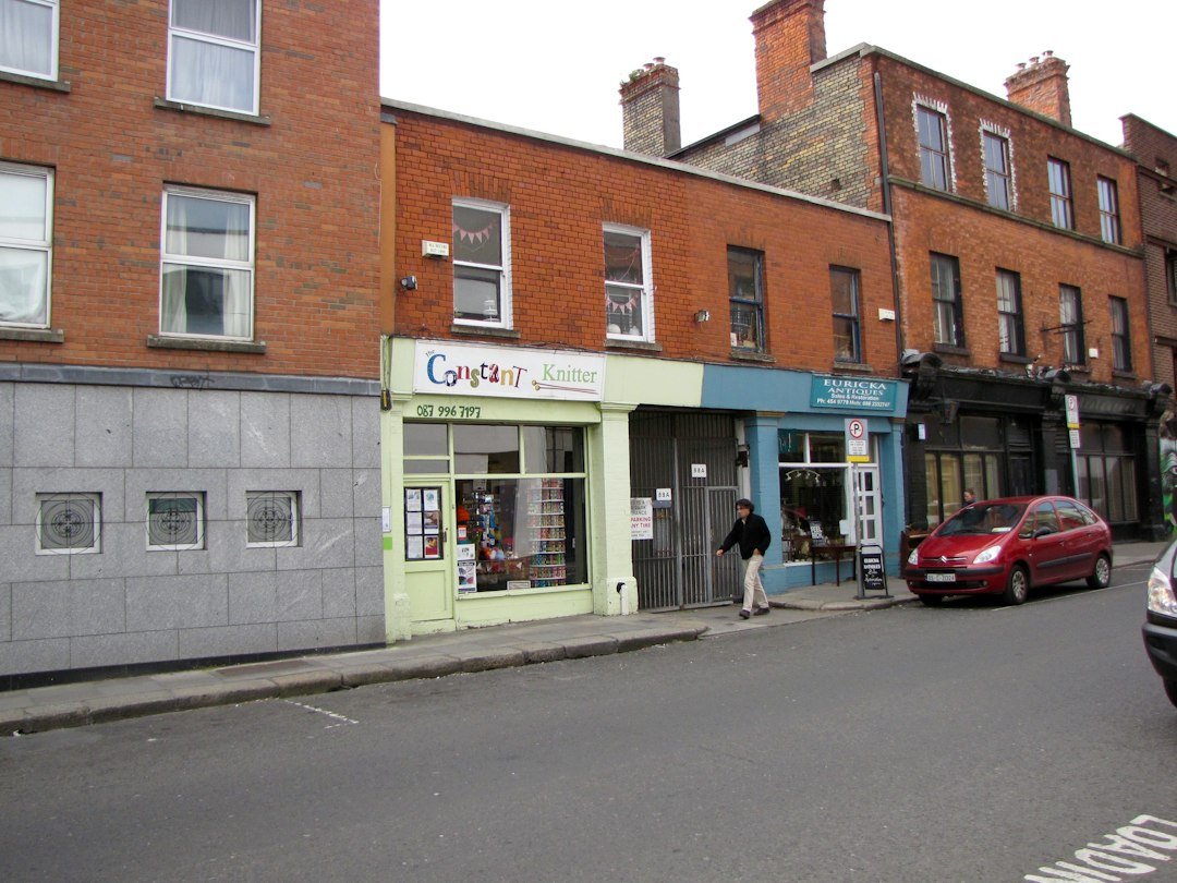 Brick high-street buildings with ground-floor shops and upper-floor windows