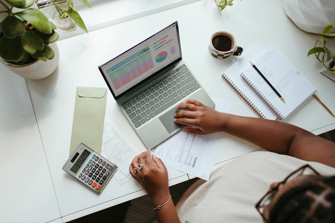 Person working at a laptop at a table while planning a mortgage application
