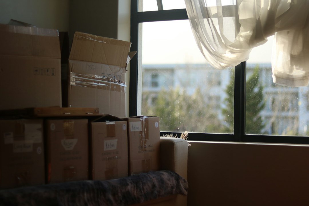 Packed moving boxes in a bright room before a house move